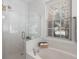 Bathroom with a glass shower and a jacuzzi tub under a bright window at 8696 Spring Chapel Ln, North Charleston, SC 29420