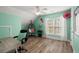 Bright bedroom featuring a large window, hardwood floors, and a hanging chair at 8696 Spring Chapel Ln, North Charleston, SC 29420