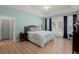 Bright bedroom featuring wood floors, tray ceilings, and a door to the outdoor deck at 8696 Spring Chapel Ln, North Charleston, SC 29420