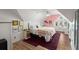 Comfortable bedroom with sloped ceilings, a plush rug, and colorful decor at 8696 Spring Chapel Ln, North Charleston, SC 29420