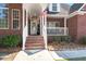 Close-up of the charming front porch, featuring classic railings and a decorative doorway at 8696 Spring Chapel Ln, North Charleston, SC 29420
