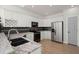 Well-equipped kitchen with white cabinets, granite countertops, stainless steel appliances, and dark tile backsplash at 8696 Spring Chapel Ln, North Charleston, SC 29420