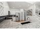 Modern kitchen with granite counters, stainless steel appliances, white cabinetry, and view of staircase at 8696 Spring Chapel Ln, North Charleston, SC 29420