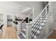 Modern staircase leading to a kitchen with breakfast bar at 8696 Spring Chapel Ln, North Charleston, SC 29420