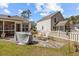 Spacious fenced backyard with a stone patio, outdoor furniture, and a covered grill area at 9021 Robins Nest Way, Summerville, SC 29485