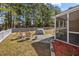 Outdoor space features a fenced-in backyard, screen porch, stone patio with seating, and mature trees at 9021 Robins Nest Way, Summerville, SC 29485