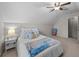 Cozy bedroom with neutral walls, sloped ceilings, a ceiling fan, and a comfortable bed with decorative pillows at 9021 Robins Nest Way, Summerville, SC 29485