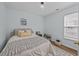 Cozy bedroom features a comfortable bed, neutral walls, modern light fixture and wood flooring at 9021 Robins Nest Way, Summerville, SC 29485