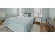 Airy bedroom features wood floors, a neutral rug, and ample natural light from the bright windows at 9021 Robins Nest Way, Summerville, SC 29485
