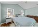 Bright bedroom with two windows, wood floors, and modern nightstands; vaulted ceiling and ceiling fan at 9021 Robins Nest Way, Summerville, SC 29485