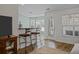 Bright dining area with hardwood floors, a glass door to the patio, and barstool seating at the breakfast bar at 9021 Robins Nest Way, Summerville, SC 29485