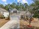 Charming home featuring a one car garage, American flag, neutral siding and mature trees at 9021 Robins Nest Way, Summerville, SC 29485