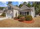 Charming home with a well-manicured lawn, an attached garage, and a welcoming front entrance at 9021 Robins Nest Way, Summerville, SC 29485