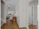 Inviting hallway with hardwood floors leading to a living room with neutral colors and furnishings at 9021 Robins Nest Way, Summerville, SC 29485