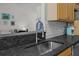 Close up of kitchen sink area with granite countertops and modern faucet fixture at 9021 Robins Nest Way, Summerville, SC 29485