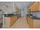 Galley kitchen with tile floors, stainless steel appliances, and light wood cabinets at 9021 Robins Nest Way, Summerville, SC 29485