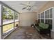 Cozy screened-in porch with a comfortable couch, ceiling fan, and view of the backyard and fence at 9021 Robins Nest Way, Summerville, SC 29485