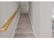 Carpeted staircase with wood railing leading to upper level at 9021 Robins Nest Way, Summerville, SC 29485