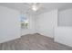 Well-lit bedroom with light grey floors, ceiling fan, and a large window at 9207 Bowen Corner Ave, Hanahan, SC 29410
