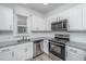 Bright modern kitchen with white cabinets, granite countertops, and stainless steel appliances at 9207 Bowen Corner Ave, Hanahan, SC 29410