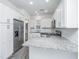 Bright kitchen features white cabinets, stainless steel appliances, and granite countertops at 9207 Bowen Corner Ave, Hanahan, SC 29410