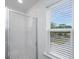 Modern bathroom with a tiled shower, glass door, and a window with natural light at 9207 Bowen Corner Ave, Hanahan, SC 29410