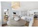 Inviting dining area with a round wooden table and stylish pendant lighting, flowing into the living space at 1020 Swamp Rose Run, Summerville, SC 29485