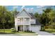 Charming two-story home with a welcoming front porch and attached garage offers comfort and style at 1020 Swamp Rose Run, Summerville, SC 29485
