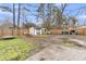 Large fenced backyard featuring play equipment and storage sheds at 106 Two Wood Ct, Summerville, SC 29483