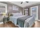Bedroom with wood-look floors, neutral colors, and a bed with a white patterned cover at 106 Two Wood Ct, Summerville, SC 29483
