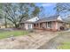 Side view of brick home featuring a large, paved driveway and beautifully landscaped yard at 106 Two Wood Ct, Summerville, SC 29483