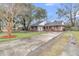 Side view of brick home featuring a large, paved driveway and beautifully landscaped yard at 106 Two Wood Ct, Summerville, SC 29483
