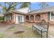 A cozy front patio area featuring brick arches and a welcoming bench at 106 Two Wood Ct, Summerville, SC 29483