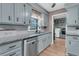 Well-lit kitchen with stainless steel appliances, gray cabinets, and wood flooring at 106 Two Wood Ct, Summerville, SC 29483