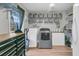 Organized laundry room with shelving, storage bins, washer and dryer, and a work table at 106 Two Wood Ct, Summerville, SC 29483