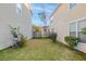 A small backyard showing a grassy area with a wooden fence between two houses at 107 Diploma Dr, Ladson, SC 29485
