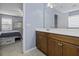 Bathroom with a wood vanity and a clear view into the bedroom, offering a seamless and open layout at 107 Diploma Dr, Ladson, SC 29485