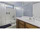 Bathroom features a wooden vanity, toilet, and a shower/tub combo with white tile surround at 107 Diploma Dr, Ladson, SC 29485