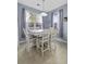 Bright and airy dining room with white furniture set and large windows for natural light at 107 Diploma Dr, Ladson, SC 29485