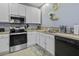 Bright kitchen featuring white cabinetry, stainless steel appliances, and modern sink fixtures at 107 Diploma Dr, Ladson, SC 29485