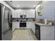 Well-lit kitchen with stainless steel refrigerator and updated cabinets, creating a welcoming culinary space at 107 Diploma Dr, Ladson, SC 29485