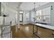 Bright living room with hardwood floors, large windows, and elegant chandelier at 107 Diploma Dr, Ladson, SC 29485