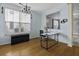 Bright living room with hardwood floors, large windows, and elegant chandelier at 107 Diploma Dr, Ladson, SC 29485