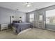 Serene main bedroom featuring a decorative headboard, dresser, and soft, neutral colors at 107 Diploma Dr, Ladson, SC 29485