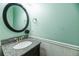 Cozy bathroom with a granite countertop vanity, round mirror, and beadboard accents at 109 Walnut Creek Rd, Charleston, SC 29414