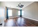 Bright primary bedroom boasting hardwood floors, ceiling fan, large windows, and neutral walls at 109 Walnut Creek Rd, Charleston, SC 29414