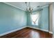 Dining area with hardwood floors, light blue walls, white trim, and a chandelier near a window at 109 Walnut Creek Rd, Charleston, SC 29414