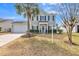 Charming two-story home with attached garage and well-manicured lawn and palm tree at 109 Walnut Creek Rd, Charleston, SC 29414