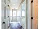 Hallway with wood floors leading to bedrooms and featuring white trim, doors, and a chandelier at 109 Walnut Creek Rd, Charleston, SC 29414