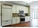 Bright kitchen features stainless appliances, ample white cabinetry, and complementary countertops with wood floors at 109 Walnut Creek Rd, Charleston, SC 29414